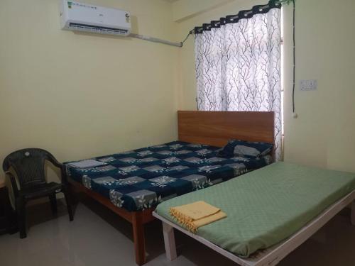 a small room with a bed and a window at Jankivihar Homestay at Prahladghat within 1km from Shri Ram Mandir in Ayodhya