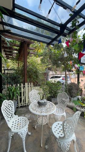 a group of chairs and a table and a table and chairs at Rocky Cafe & Mini Apartment in Siem Reap