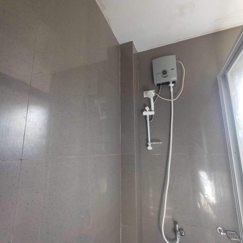 a shower with a shower head in a bathroom at Mountain cove villa in Pagudpud