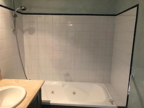 a bathroom with a bath tub and a sink at Le Domaine du Château des Gipières By Ateya Vacances in Montbrun-les-Bains