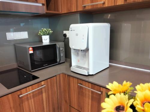 a microwave and a coffee maker on a kitchen counter at Lost World of Tambun, Sunway Onsen Studio, 1BR, 2-4pax in Tambun