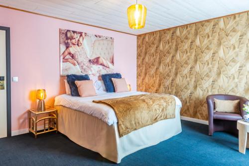 a bedroom with a bed and a painting on the wall at Achouffe Valley in Achouffe