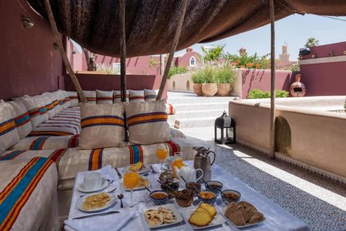 a table with plates of food on top of a roof at Riad Les Yeux Bleus in Marrakesh