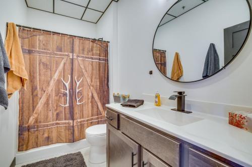 a bathroom with a wooden shower curtain and a sink at Cashton Studio Apartment Steps to Downtown! 