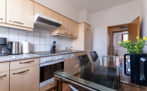 a kitchen with a table and a stove top oven at Haus 4 Jahreszeiten- Fewo Sommer mit Terrasse und Bio-Kamin in Ostseebad Karlshagen