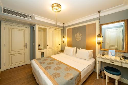 a hotel room with a bed and a desk at Raymond Blue Hotel in Istanbul