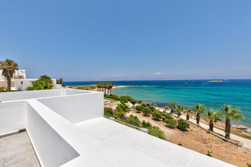 a view of the ocean from the balcony of a house at Paros Blue Dolphin FULLY RENOVATED by RIVEA GROUP in Chrissi Akti