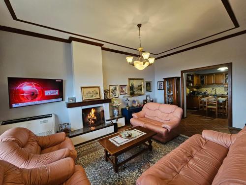 a living room with two couches and a tv at Vila DANI near Castle and Old Bazar in Krujë