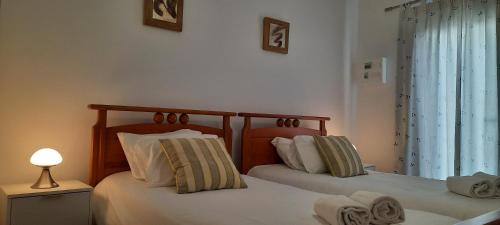 two beds sitting next to each other in a bedroom at Casa do Meio in Lamas
