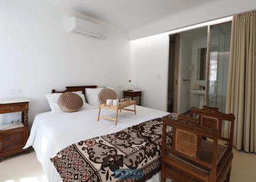 a bedroom with a bed with a table on it at MyStay - Casa Matriz Séc XVI in Penafiel