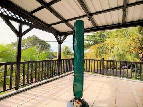 a green object is sitting on a balcony at Tropical villa Pereybere in Pereybere