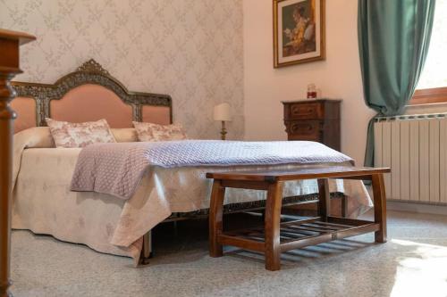 a bedroom with a bed with a wooden frame and a table at A Casa di Rut - Appartamento in Moiano