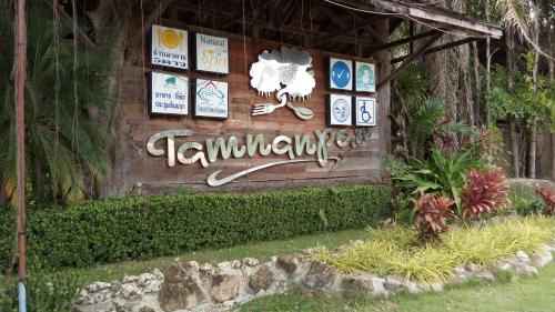 a sign on the side of a building at Beachfront Cozy Studio in Ban Phe