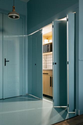 an open door in a room with a kitchen at Gellerico Apartments Deák Square in Budapest