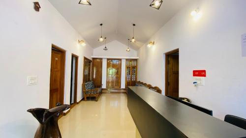 a hallway with a long desk in a building at Misty Green Coorg in Madikeri