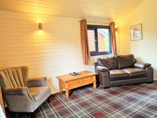 a living room with two chairs and a coffee table at Beaver 1 HuntersMoon-warminster-Wiltshire in Warminster