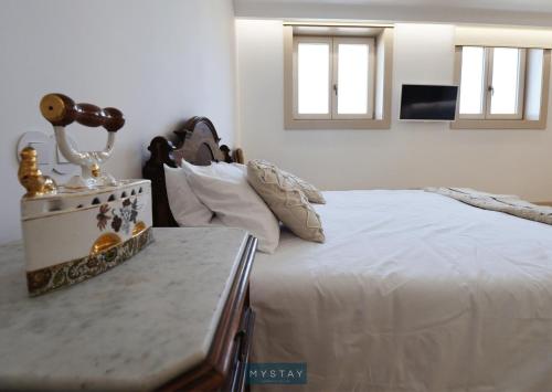 a bedroom with a bed and a table with a lamp at MyStay - Casa Matriz Séc XVI in Penafiel
