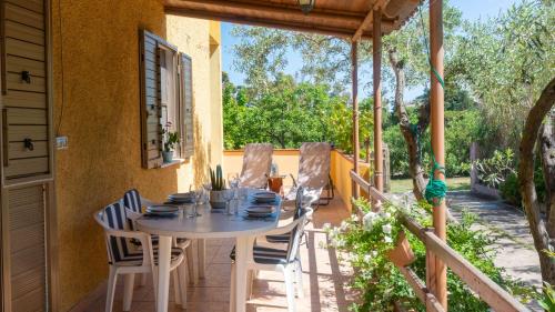 a table and chairs on the porch of a house at Casa dei Lidi in Budoni