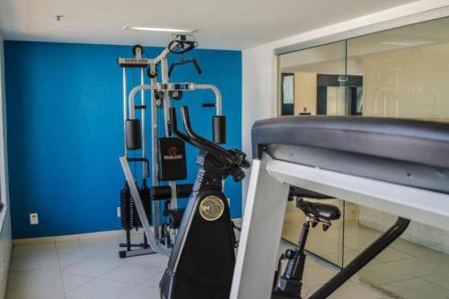 a gym with a treadmill and a mirror in a room at Mont Blanc Apart Hotel Quarto 102 in Duque de Caxias
