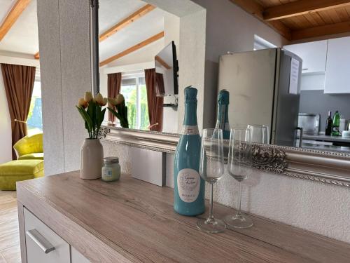 a counter with two wine bottles and glasses on it at Holiday Home Emma in Bihać