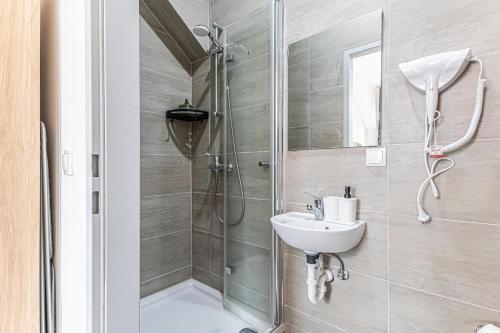 a bathroom with a shower and a sink at Westbahnhof Kingbed 1BR Apt with ensuite washer in Vienna
