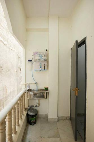 a small bathroom with a sink and a stairway at Legend's studio room with Mini kitchenette in Hyderabad