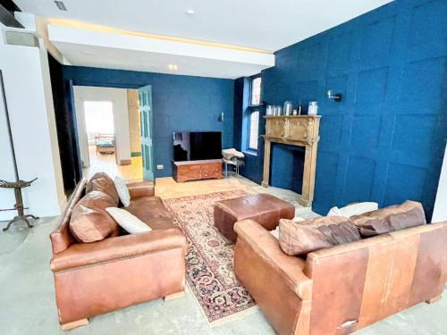 a living room with two couches and a fireplace at Remarkable 7-Bed House in London in London