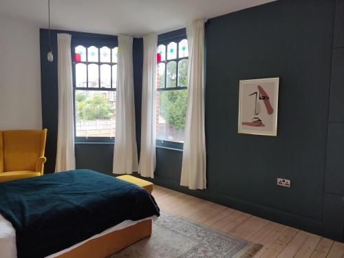 Remarkable 7-Bed House in London في لندن: غرفة نوم بسرير ونوافذ