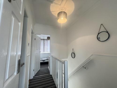 a hallway with a staircase with a ceiling fan at Okapi peace of paradise in Leeds