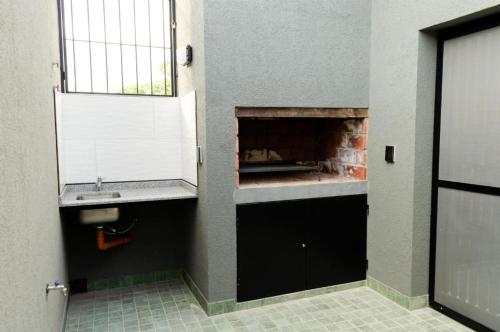a bathroom with a sink and a fireplace at N3-Catamarca in Villa Constitución
