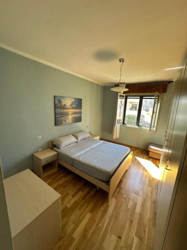 a bedroom with a bed and a wooden floor at You will love it in Durrës