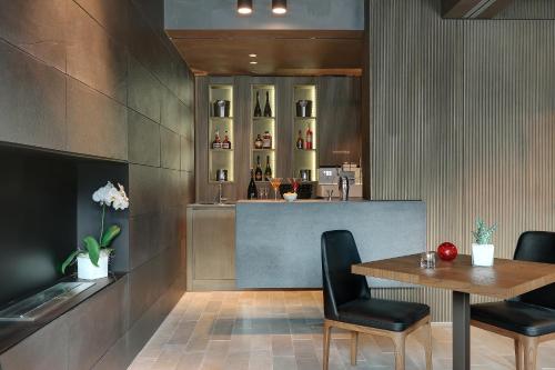 a restaurant with a table and chairs and a bar at Grand Hotel Campione in Campione dʼItalia