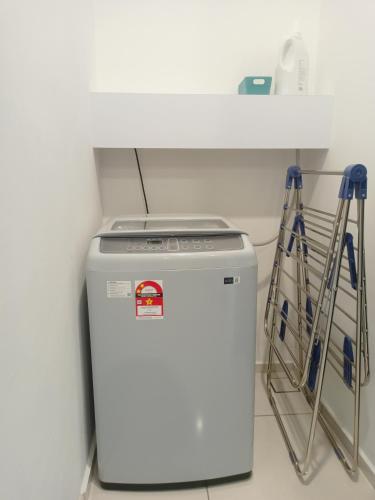 a small white refrigerator sitting in a room at Lost World of Tambun, Sunway Onsen Studio, 1BR, 2-4pax in Tambun