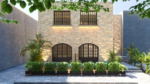 a building with windows and plants in front of it at Arthur Suites in Old Town in Rhodes Town
