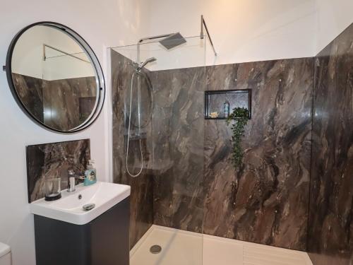 a bathroom with a sink and a mirror at The Old Parlour in Rhyl