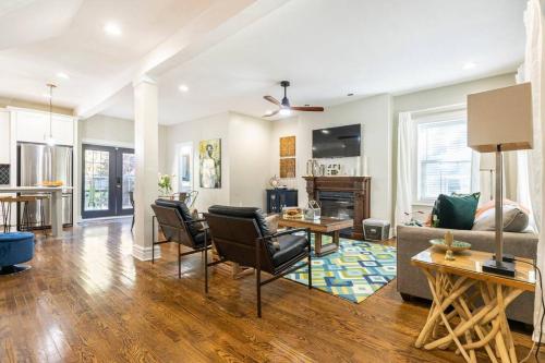 a living room with a couch and a table at Chic 4BR 3BA Historic Home Near Country Club Plaza in Kansas City