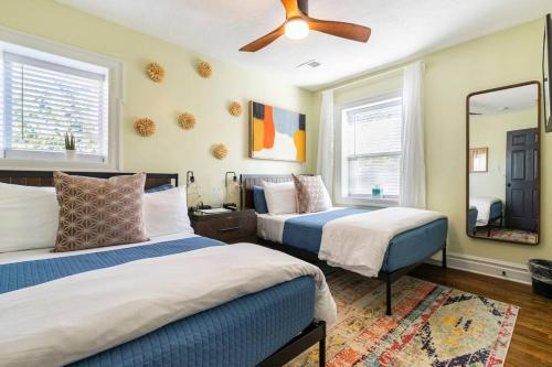 a bedroom with two beds and a ceiling fan at Chic 4BR 3BA Historic Home Near Country Club Plaza in Kansas City