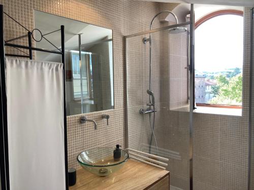 W łazience znajduje się szklana umywalka i prysznic. w obiekcie charmant appartement centre ville w mieście Millau
