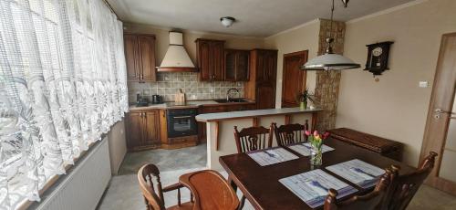 a kitchen with a wooden table and a kitchen with a counter at Apartmá Kanada in Štramberk