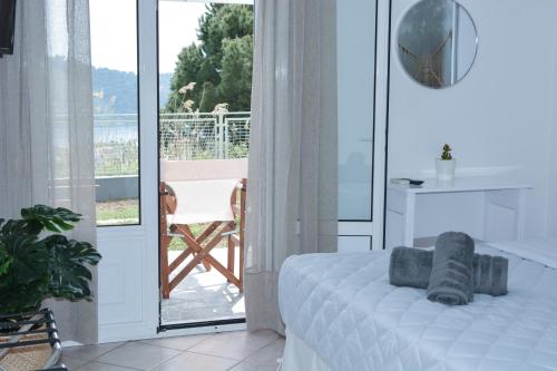 a bedroom with a bed and a view of a balcony at Daphne's studio 2 in Skiathos