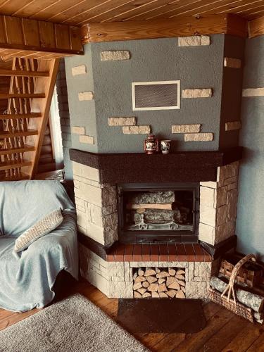 a living room with a brick fireplace in a house at Viesu nams RŪĶĪŠI in Rugāji