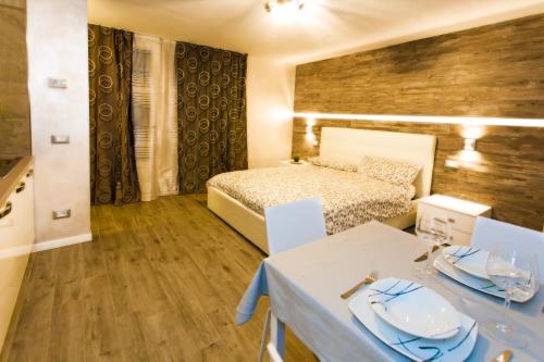 a bedroom with a bed and a table with dishes on it at Residence Delle Rose in Tremosine Sul Garda