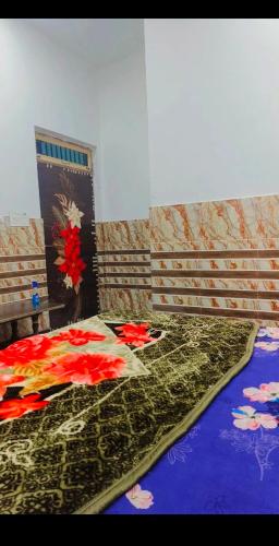 a bedroom with a bed with flowers on it at Shri Ganesh Seva Sadan in Govardhan