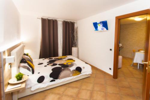 a bedroom with a bed with a cow blanket at Residence Delle Rose in Tremosine Sul Garda