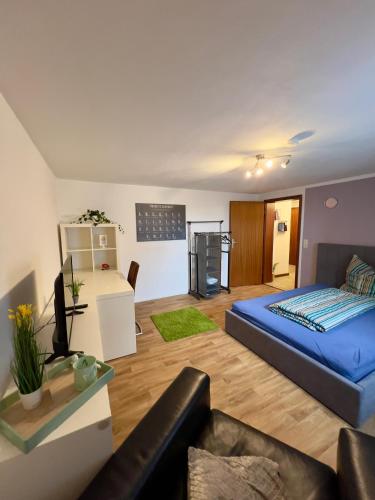 a living room with a bed and a couch at Ferienwohnung im Vorharz in Liebenburg