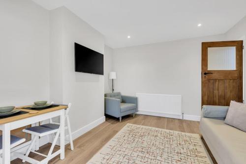 a living room with a couch and a table at Bromstone House, Broadstairs in Broadstairs