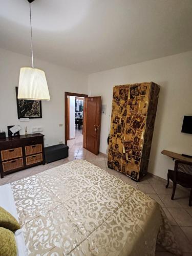 a bedroom with a bed and a dresser and a table at B&B A Casa di Mael in San Costanzo