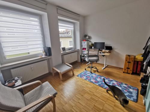 a living room with a dog standing in the middle of the room at Center Schwabing Spacious flat in Munich