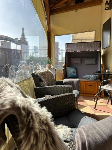 a room with chairs and a bed and a window at Pension Zur Alten Post in Havelberg