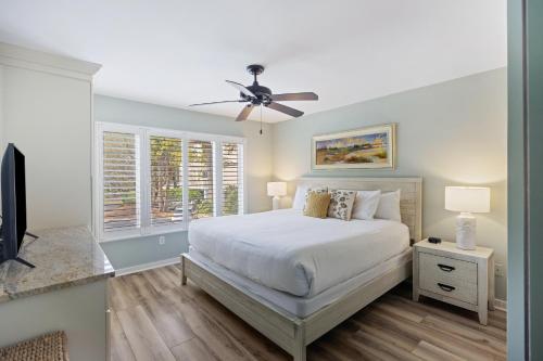 a bedroom with a bed and a ceiling fan at 8A Seagrove Villa in Isle of Palms